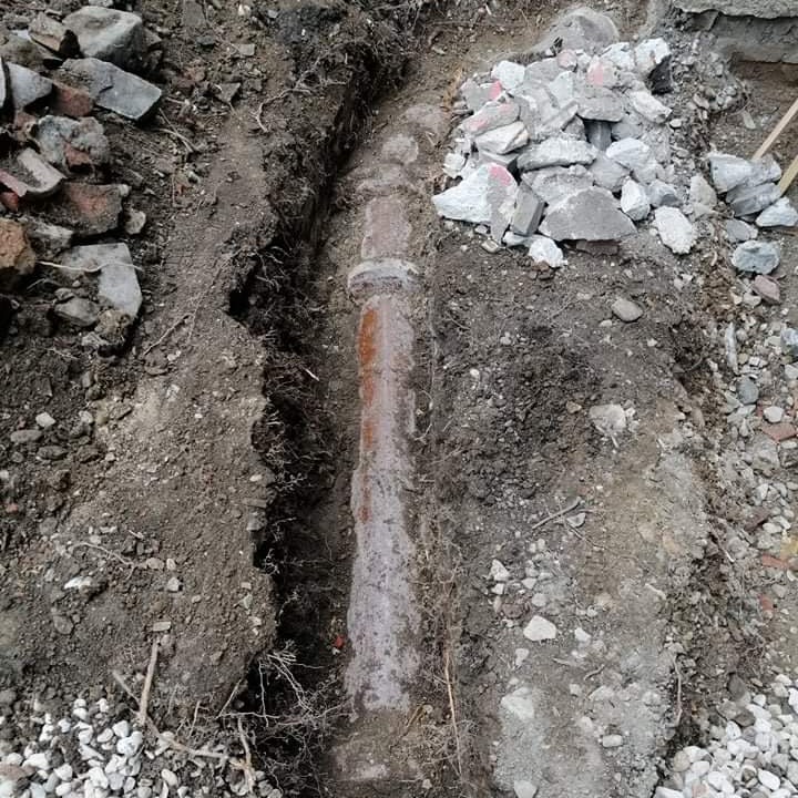 Alter Steinzeugkanal im freigelegten Boden eines Innenhofs