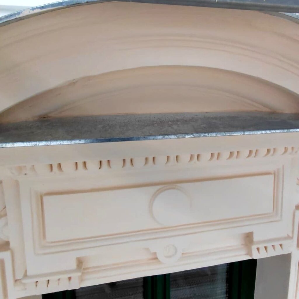 Sanierte Fensterverdachung mit Rundbogen, Zahnfries und neuer Verblechung